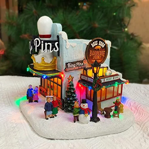 Moments in Time Christmas Village Building, King Pins Bowling Alley and Boss Hogg Barbeque Joint with LED Lights and Christmas Music Battery Operated (not Included) (H x x D)